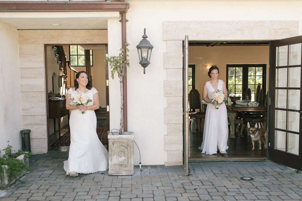 Two brides having a first look at their wedding day together