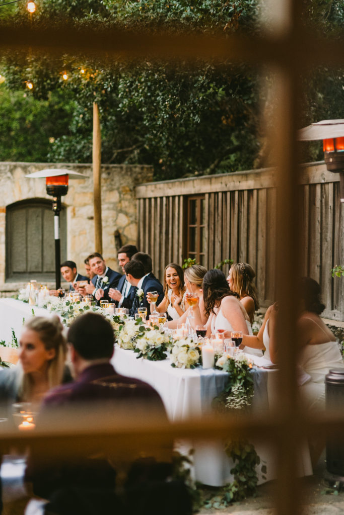 Wedding party seated at a head table in the Rose Patio