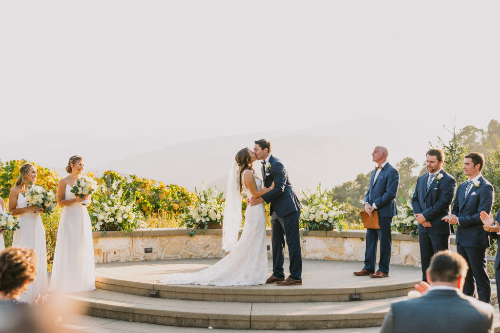 Couple's first kiss on the ceremony site at Holman Ranch