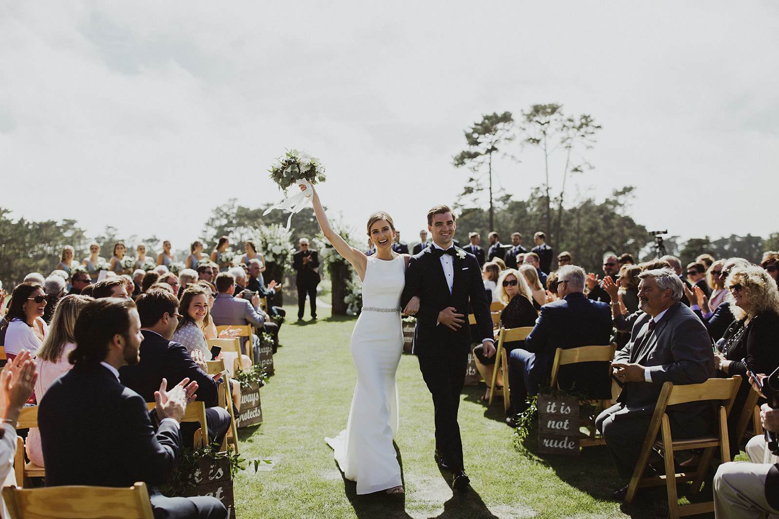 Couple celebrating back down the aisle after ceremony