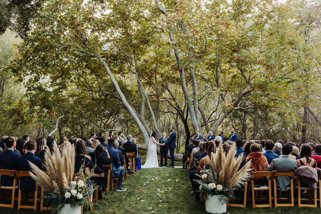 Bride and Groom holding hands during ceremony at Gardener Ranch