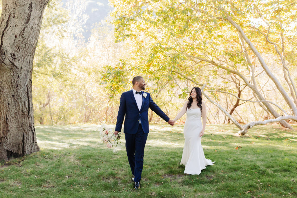 Bride and Groom walking on lawn