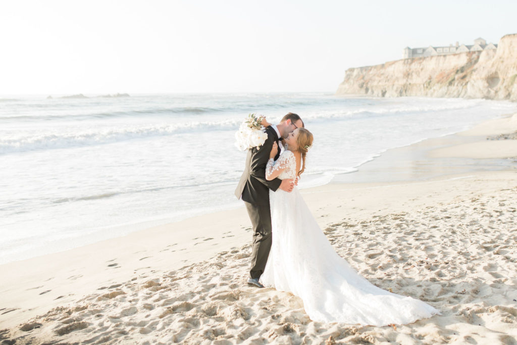 Bride and Groom posing on beach